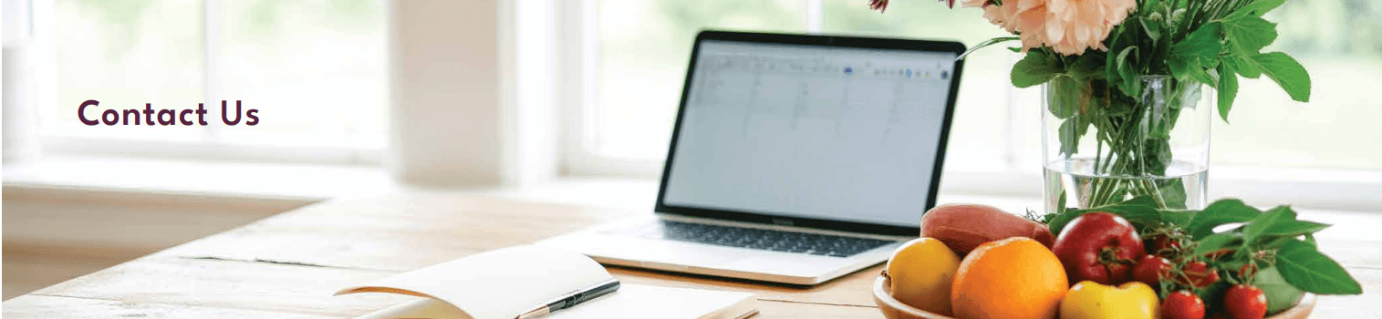 Open notebook, laptop, and a bowl of fruit beside the words Contact Us